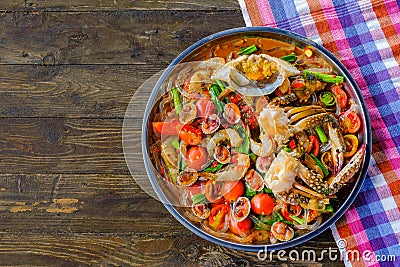Som Tam Seafood Spicy Papaya Salad with salted crab, on wooden Stock Photo