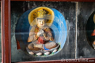 Some of the 10.000 brick statues of the Buddha with preserved colors that are inlaid in the walls of the Po Pagoda of Kaifeng Stock Photo