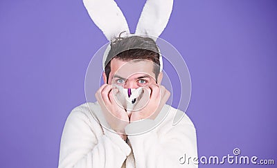 Some bunny loves you. Man wearing rabbit ears. Easter hare. Bearded man in easter rabbit costume. Happy Hipster dressed Stock Photo