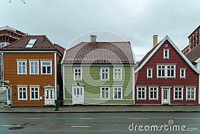 some colorful wooden buildings on the side of a road with white windows Stock Photo