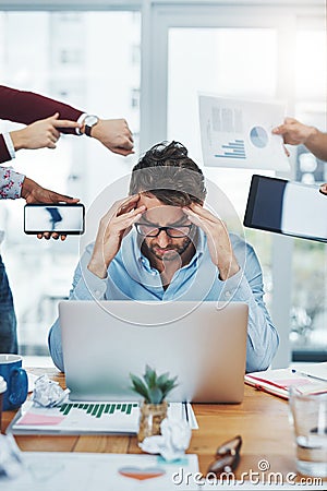 Some days will be more demanding than others. a young businessman looking stressed out in a demanding office environment Stock Photo