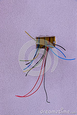 Some different electric cables looking from wall Stock Photo
