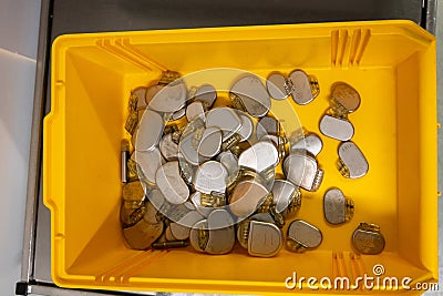 Some explanted pacemakers lie in a yellow plastic box Stock Photo