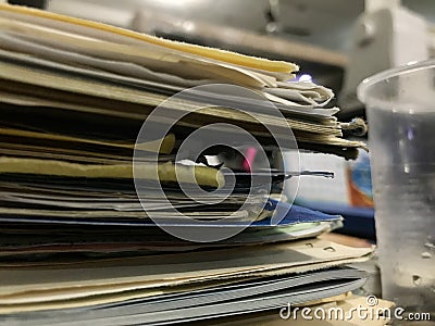 Some file folders stacked on top of a desk Stock Photo