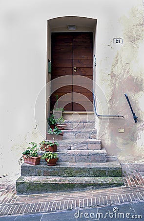 Flower pots adorning steps leading to a charming doorway Stock Photo