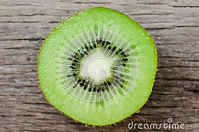 Some fresh Kiwi Fruits on an old wooden table Stock Photo