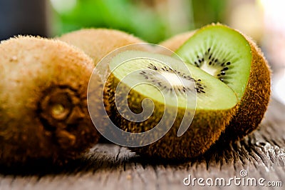 Some fresh Kiwi Fruits on an old wooden table Stock Photo