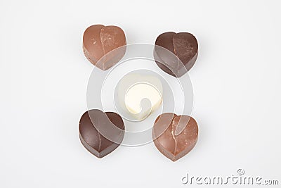 Some heart dark milk chocolate pralines in top view in white background Stock Photo