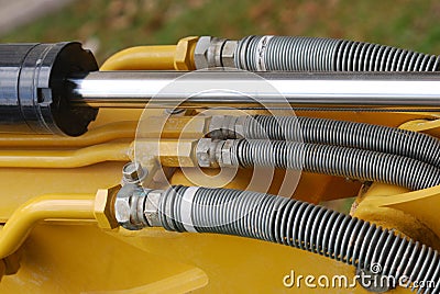 Some industrial hydraulics shaft and fluid hoses Stock Photo