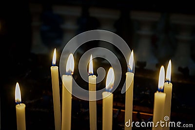 Some lit candles in a church Stock Photo