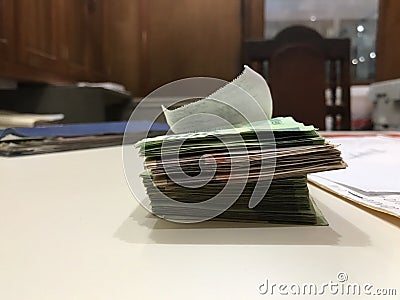 Some mexican peso money bills stacked on a beige coloured table Stock Photo