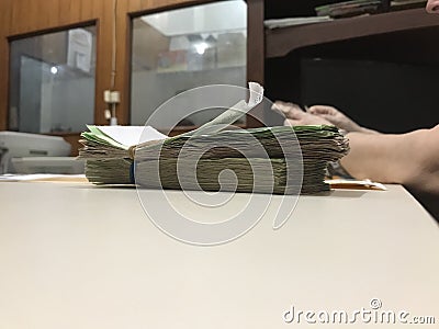 Some mexican peso money bills stacked on a beige coloured table Stock Photo
