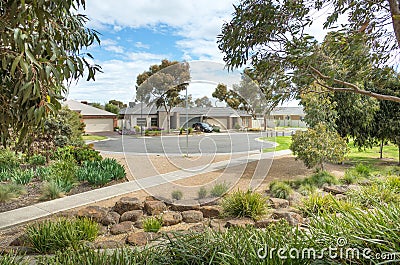 Some modern Australian homes/houses in a suburb near a landscaped park with a variety of native plants and trees. Melbourne, VIC Stock Photo