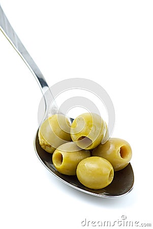 Some pitted green olives in the spoon Stock Photo