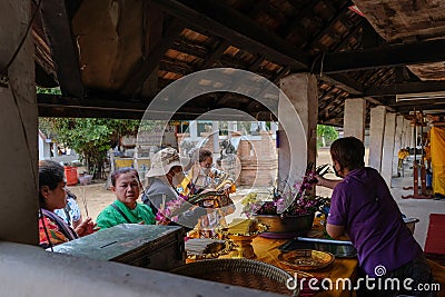 Some prayers buy flower for praying at Wat Phra That Lampang Luang in Lampang province Editorial Stock Photo