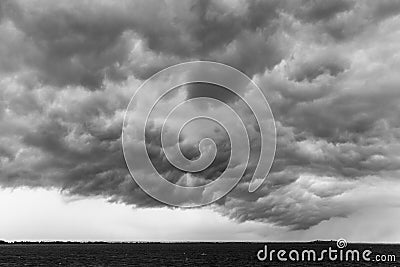 Some spectacular and menacing clouds over a lake, with a distant Stock Photo