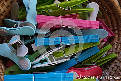 Some types of colored clothespins, to hang clothes in a wicker basket Stock Photo