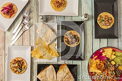 Some typical Mexican dishes with nachos with guacamole and meat, Stock Photo