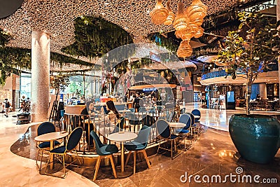 Some women chatting and drinking coffee in luxury hall of urban shopping mall with great decorations Editorial Stock Photo