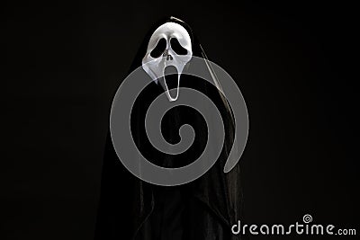 Someone in black cover with white ghost mask cosplay to devil ac Stock Photo