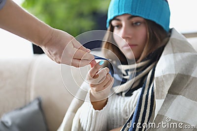 Someone give young woman thermometer to measure temperature Stock Photo