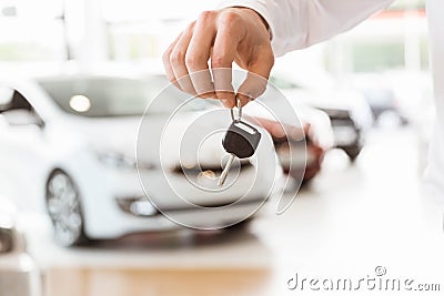 Someone holding car keys by his fingertips Stock Photo