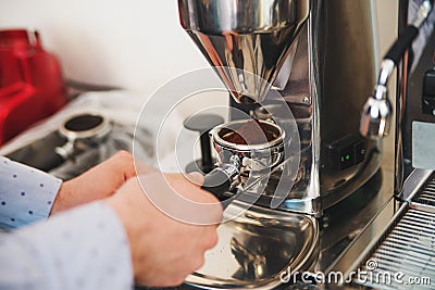 Someone holdinh part of coffee machine with grind coffe beans Stock Photo