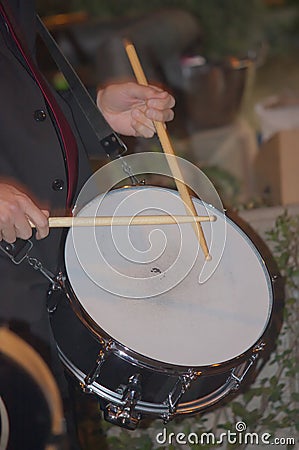 Someone plays the drum with the two wooden drumsticks Stock Photo
