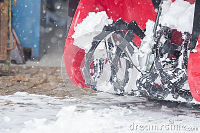 Someone uses a snowthrower outdoors in winter while it is snowing Stock Photo