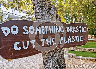 Something drastic cut the plastic wooden sign on the tree trunk Stock Photo