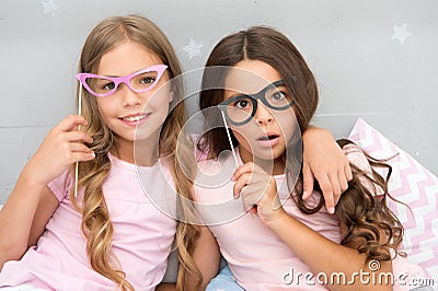 Something went wrong way. Children posing with confused face photo booth props. Pajamas party in bedroom. Friends cute Stock Photo