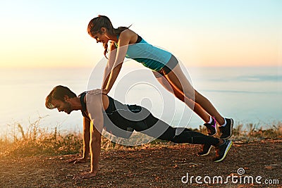 Sometimes you need that extra push...Full length shot of an attractive young woman on top of her boyfriends back while Stock Photo