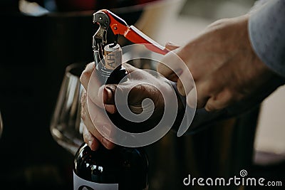 Sommelier opening wine bottle in the wine cellar Stock Photo