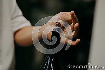 Sommelier opening wine bottle in the wine cellar Stock Photo