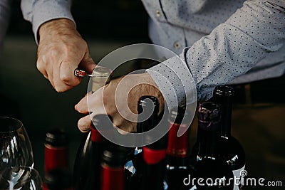 Sommelier opening wine bottle in the wine cellar Stock Photo