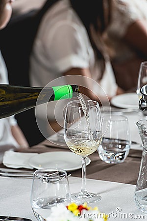 Sommelier pouring wine into glass at wine and food tasting Stock Photo