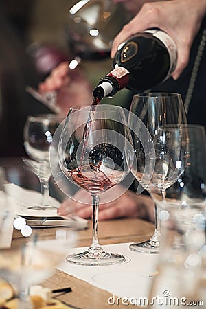 Sommelier pouring wine into glass at wine tasting Stock Photo