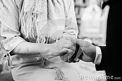 Son hold mother hand at blessings. Groom at church Stock Photo