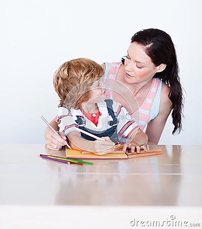 Son and mother drawing looking at each other Stock Photo