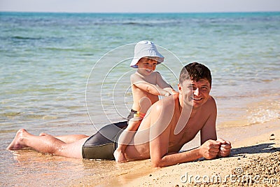 Son sitting astride a father Stock Photo