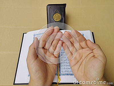 son's hands in mosque praying and reading holly book quran together islamic education concept Editorial Stock Photo