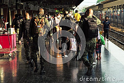 Songkhla, Thailand : April 11, 2021 - Rear view group of soldiers walking in the platform of Hat Yai train station for security Editorial Stock Photo