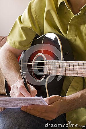 Songwriting on acoustic guitar Stock Photo