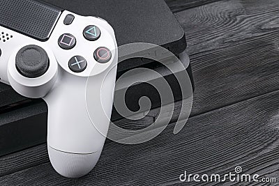 Sony PlayStation 4 Slim 1Tb revision and dualshock game controller. Game console with a joystick. Home video game console Editorial Stock Photo