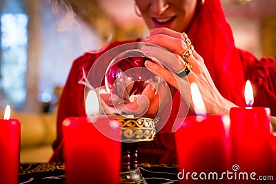Soothsayer in Seance with Crystal ball and smoke Stock Photo