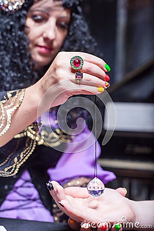 Sorceress reading somebody's hand Stock Photo