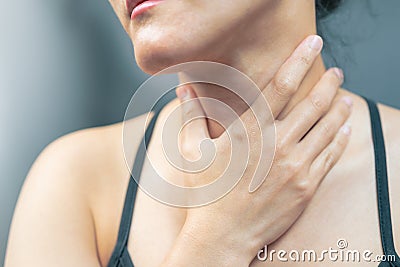 Sore throat pain women. Woman hand touching neck with sore throat feeling bad. Healthcare and medicine concept Stock Photo