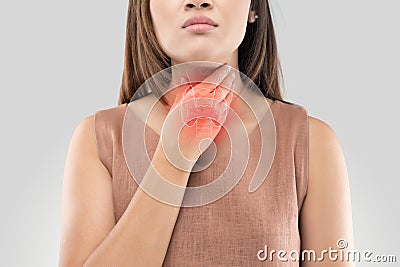 Sore throat woman on gray background Stock Photo