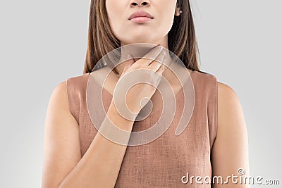 Sore throat woman on gray background Stock Photo