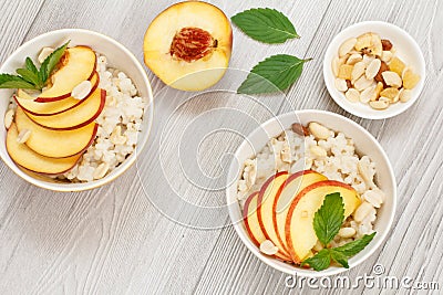 Sorghum salad with nuts and fresh peach on wooden board Stock Photo
